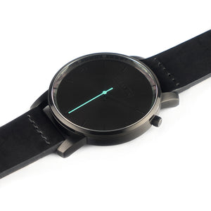 All black Hervor watch with black leather strap and a turquoise accent second hand