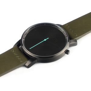All black Hervor watch with olive khaki green leather strap and a turquoise accent second hand