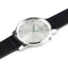 Load image into Gallery viewer, All silver Hervor watch with black leather strap and a turquoise accent second hand