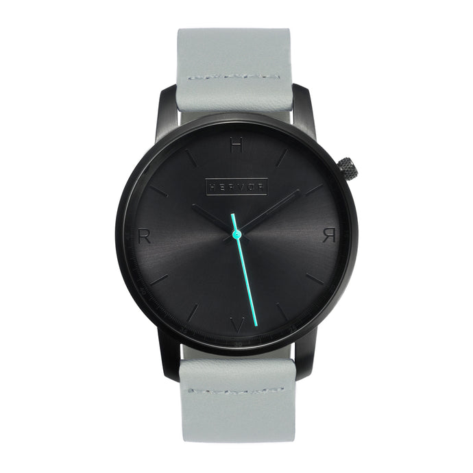 All black Hervor watch with dove grey leather strap and a turquoise accent second hand