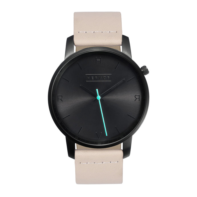 All black Hervor watch with light pink skin tone leather strap and a turquoise accent second hand