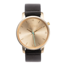 Load image into Gallery viewer, All gold Hervor watch with black leather strap and a turquoise accent second hand