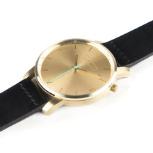 Load image into Gallery viewer, All gold Hervor watch with black leather strap and a turquoise accent second hand