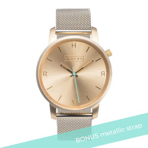 All gold Hervor watch with gold metallic mesh strap and a turquoise accent second hand