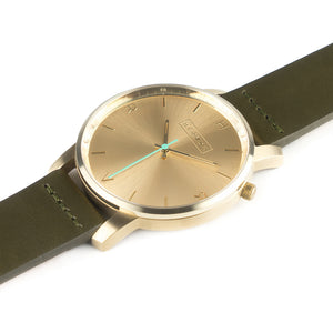 All gold Hervor watch with olive khaki green leather strap and a turquoise accent second hand