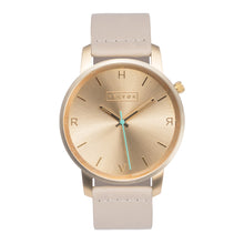 Load image into Gallery viewer, All gold Hervor watch with light pink skin tone leather strap and a turquoise accent second hand