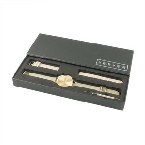 Gold Hervor watch in black packaging includes strap adjustment tool