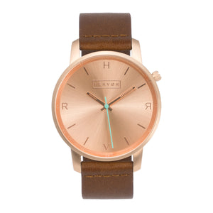 All rose gold Hervor watch with fox brown leather strap and a turquoise accent second hand