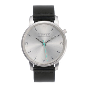 All silver Hervor watch with black leather strap and a turquoise accent second hand