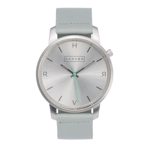 All silver Hervor watch with dove grey leather strap and a turquoise accent second hand