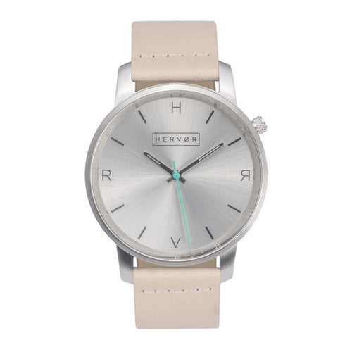 All silver Hervor watch with light pink skin tone leather strap and a turquoise accent second hand