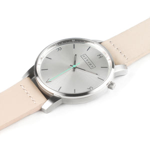 All silver Hervor watch with light pink skin tone leather strap and a turquoise accent second hand